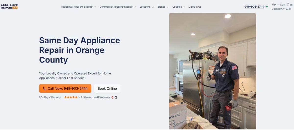 Appliance repair technician in a blue uniform standing in a kitchen beside a large appliance, giving a thumbs-up.