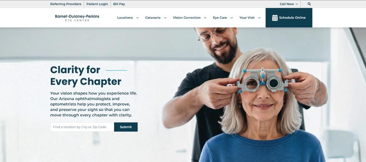 Optometrist helps an older woman with a trial frame during an eye exam in a bright clinic environment.