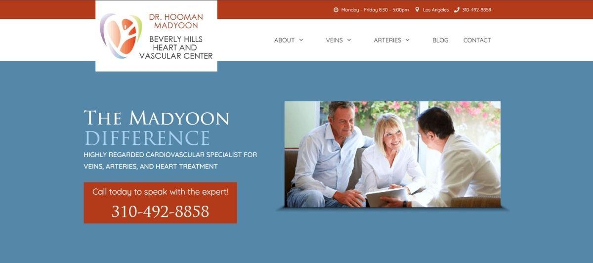 Group of doctors discussing a patient with a tablet on a blue hero background reading 'The Madyoon Difference' and a red/orange phone box with 310-492-8858 (Bevery Hills Heart and Vascular Center).