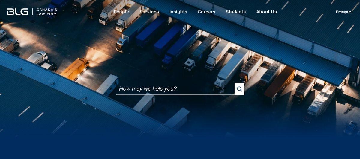 Aerial view of a truck yard with loading docks at dusk, representing logistics and transport services for a business site.
