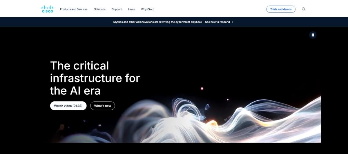 Cisco hero banner: 'The critical infrastructure for the AI era' over a black background with abstract flowing light artwork; call-to-action buttons 'Watch video' and 'What’s new'