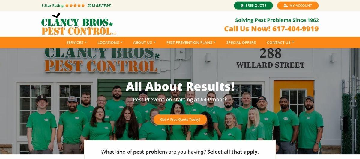 Group photo of Clancy Bros. Pest Control team in green shirts standing in front of their storefront.
