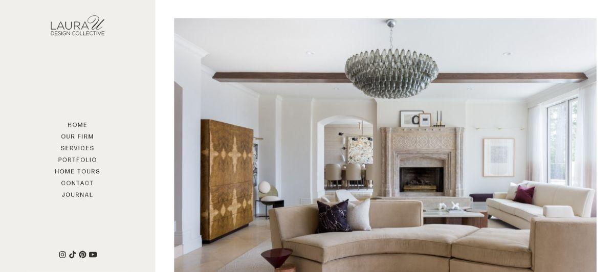 Living room lobby scene with a curved beige sectional, a large chandelier, and a stone fireplace in a bright, modern-meets-classic space (designer homepage hero).