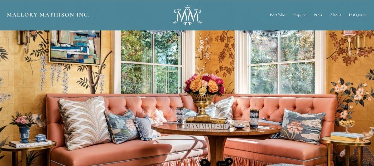 Stylish lounge scene with a coral tufted sofa, patterned pillows, and a round wooden coffee table in a bright, floral-inspired room.