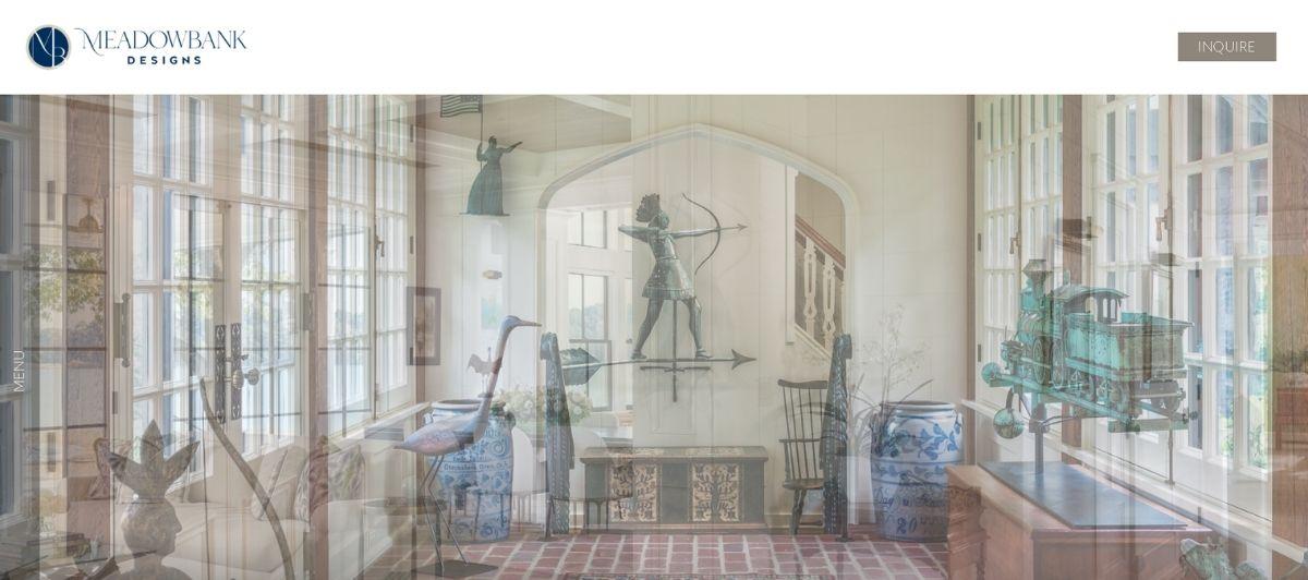 Meadowbank Designs showroom interior with antique sculptures, blue-and-white porcelain jars, and large windows fill the space.