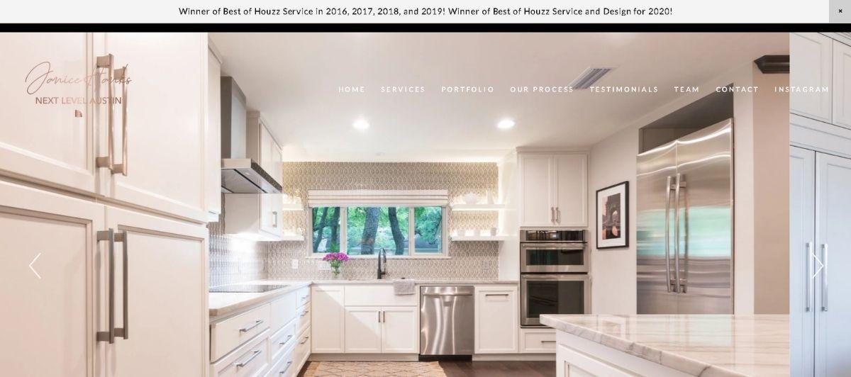 Bright modern white kitchen with stainless steel appliances and a large island; navigation bar at the top. Considerable natural light from the window above the sink.