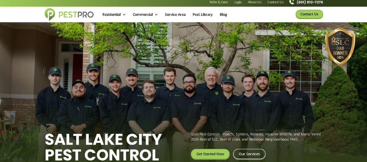 Group of PestPro pest control technicians in black uniforms standing in front of a house, posing for a team photo in a residential setting.