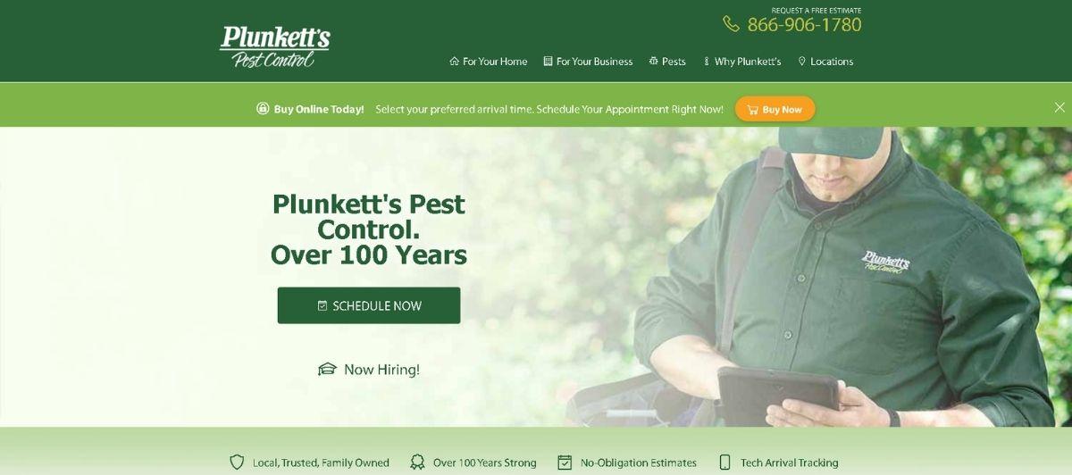 Plunkett's Pest Control homepage hero: a technician in a green uniform using a tablet outdoors with a prominent Schedule Now button on a green banner.