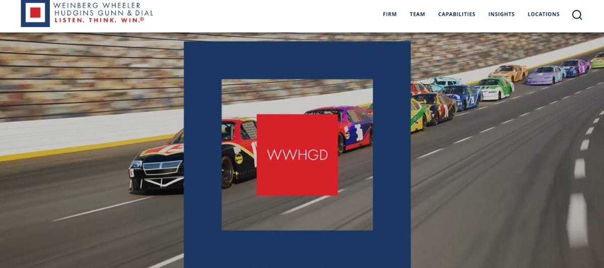 Hero banner showing a race track background with a blue square frame and a red square logo in the center bearing the initials WWWHDG, representing the firm's branding.