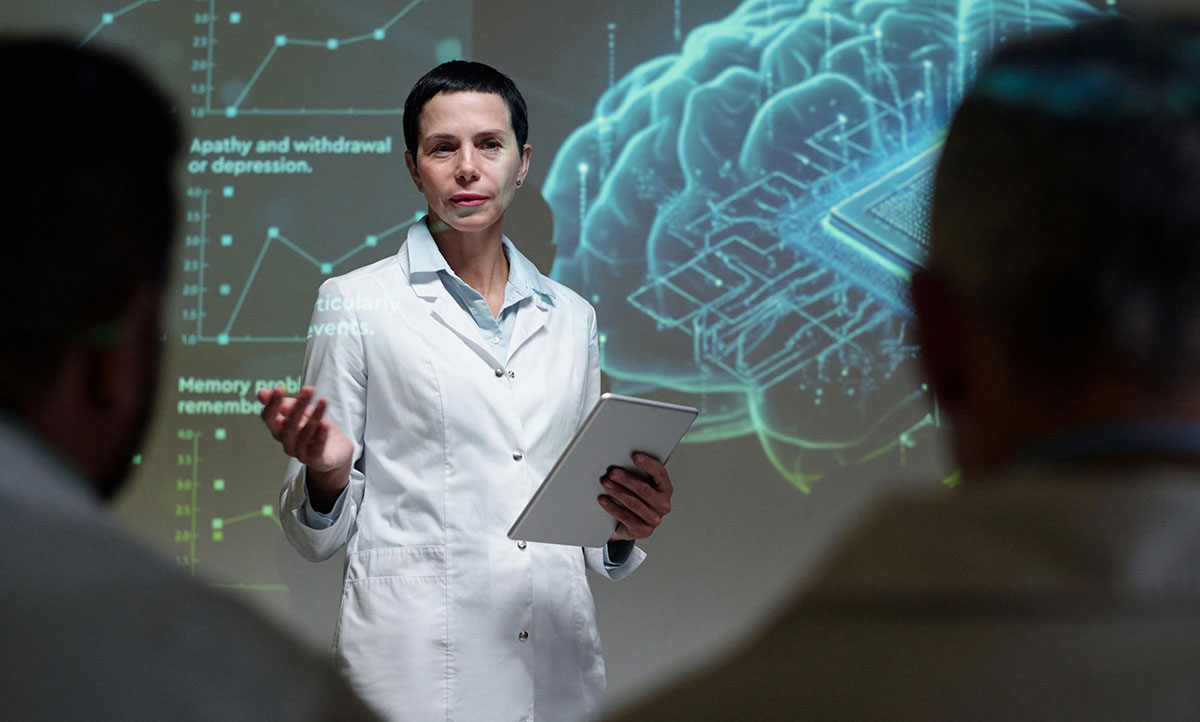 Scientist in a white lab coat explains neural data, holding a tablet with a holographic brain and charts behind.