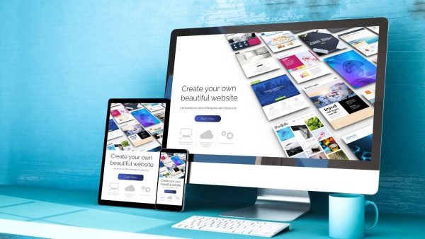 Desktop monitor displays a collage of website templates with the headline 'Create your own beautiful website' while a tablet and phone show the same designs on a teal workspace.