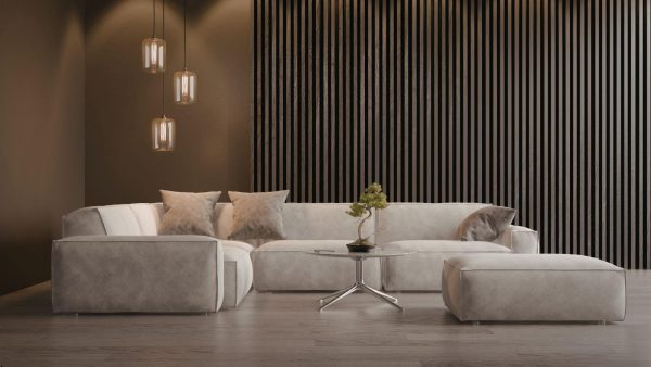 Modern gray sectional sofa with cushions in a minimalist living room, featuring a round glass coffee table and hanging pendant lights on the left side.