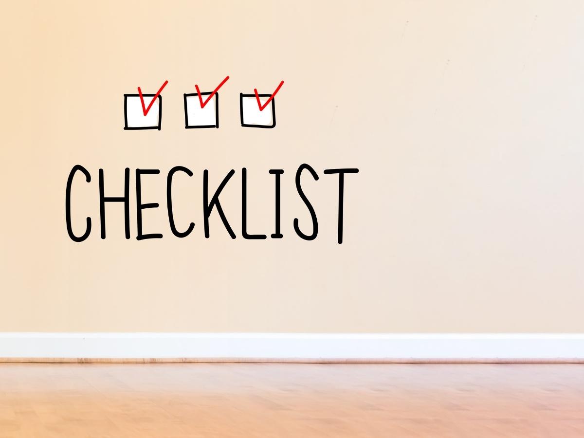 Beige wall with the word CHECKLIST and three small white checkboxes above it, each with a red checkmark.