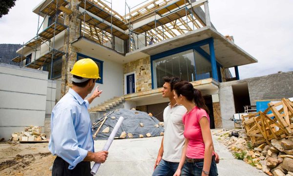contractor showing house construction to couple