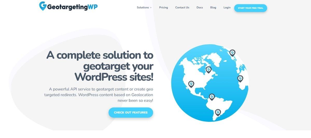 Hero section with the GeotargetingWP logo and the headline 'A complete solution to geotarget your WordPress sites!' shown beside a blue globe with location pins on the right, conveying the geotargeting service."
