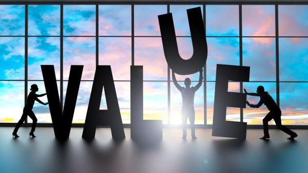 Silhouetted team rearranging giant black letters to spell 'WALLET' in a sunrise-lit room.