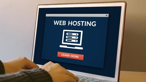 Web hosting promo card on a laptop screen with a server icon and a Learn More button
