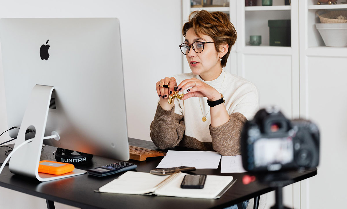 woman at desktop on camera