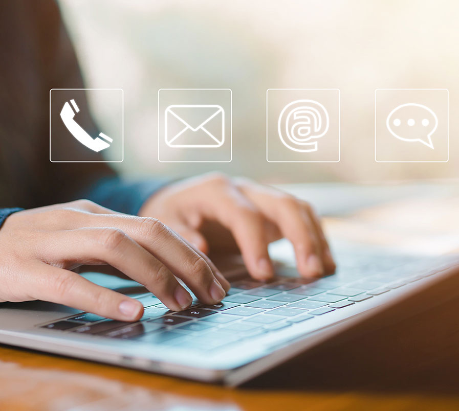 image of hands on keyboard with phone icon, envelope, @, and speech bubble icon